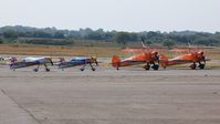  - Line up of XA-41's of the Red Bull Matadors and Boeing Stearman Kaydet biplanes of the Brietling Wingwalkers at Swansea Airport prior to displaying at the Wales National Air Show. - by Roger Winser
