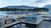 - Early overcast Sunday morning at Harbour Air terminal in Coal Harbour.  Stanley Park and the North Shore mountains are in the background. - by M.L. Jacobs