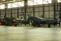  - PZ865 Hawker Hurricane IIC and PM631 Supermarine 389 Spitfire PR.XIX in the Battle of Britain Memorial Flight hangar - by Chris Hall