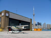  - Showing the old hangar and skyline behind. - by Ray Barber