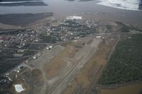  - Fort Yukon, Alaska.  Minor flooding of ramp during breakup of Yukon River.  Taken from Wright Air N4637U piloted by Dave Lorring. - by David Lee