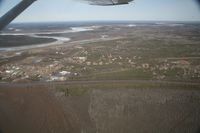  - Fort Yukon, Alaska.  Minor flooding during breakup of Yukon River.  Taken from Wright Air N4637U piloted by Dave Lorring. - by David Lee