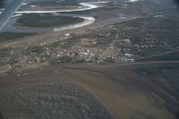  - Fort Yukon, Alaska.  Minor flooding of ramp during breakup of Yukon River.  (River seen in picture flows into the Yukon which is to the left of the image)  Taken from Wright Air N4637U piloted by Dave Lorring. - by David Lee