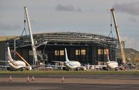 - Hangar extension for new B748BBJ taking shape - flyby by G-EMOL. - by John Coates
