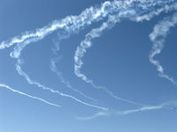  - Warbirds in turning echelon flight with smoke - by Doug Robertson
