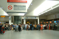  - Hustle and Bustle at a  departure gate at London's Gatwick Airport - by Ron Coates