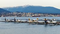  - Harbour Air terminal in Coal Harbour in the early spring evening.  City of North Vancouver across Vancouver Harbour in the background. - by M.L. Jacobs