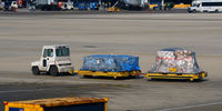  - Baggage cart towed on the  ramp at O'Hare - by Ronald Barker