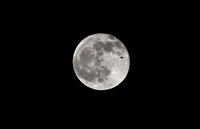  - Embraer in front of moon - by Paul H