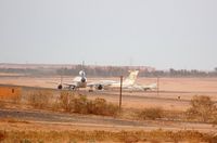  @ Sebha Airport - Remote stand with stored L1011 of Kallat El-Saker Air Company (one of three), a Il76 of LAA and a MIG29. View from hotel. - by FerryPNL