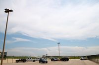 - View from the north side of the airport, looking south at a line of thunderstorms moving east. - by Glenn E. Chatfield