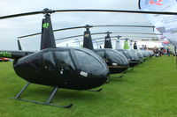  - Line up of Robinson's at AeroExpo 2014 - by Chris Hall