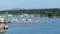  - Harbour Air terminal in Coal Harbour.  Stanley Park in the background. - by M.L. Jacobs