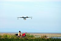  - Enjoying the sea breeze and watching the seaplanes. - by metricbolt