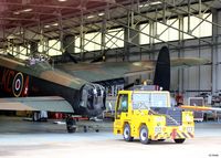  - A view of he Battle of Britain Memorial Flight (BBMF) at RAF Coningsby with Lancaster B.1 PA474 being prepared for tow. - by Clive Pattle