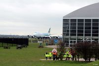  - A view of the Runways Restaurant and Concorde hangar at Manchester Airport EGCC viewing area, highlighting its close proximity to the aircraft, in this case a B747-867F Cargo plane of Cathay Pacific. - by Clive Pattle