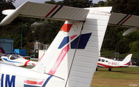  - The GA parking area viewed through the tail of a dead Tomahawk in the airport graveyard. - by Clive Pattle