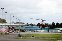 - Eastwards facing shot of the apron at Dundee EGPN with a Northern Lighthouse EC135 (G-CGPI) hovering to land. - by Clive Pattle
