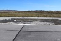  - A darkened area of tarmac on the edge of the main runway at Port Stanley (SFAL) shows where repairs were made following the Vulcan Black Buck bombing sortie in May 1982.  - by Clive Pattle