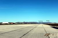  - Lookg westwards down the runway at Port Stanley SFAL, with the airport terminal buildings on the left and the prominent mountains in the background, most of which featured heavily in the final battles in 1982. - by Clive Pattle