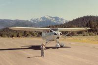  - N6905D at Alpine Co with its veteran pilot pointing toward the runway(unknown why) as he eats lunch.View is almost due south.Trail to the Walker river is on the right of 05D. - by S B J