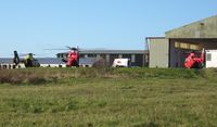  - A police and two air ambulance emergency services helicopters on the apron by the Wales Air Ambulance base at Hangar 1. - by Roger Winser