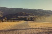  - View is down runway and to the north.42E is seen departing in the best direction toward the lake. Keep in mind that prop damage (with some tricycle planes) is possible due to gravel runway. - by S B J