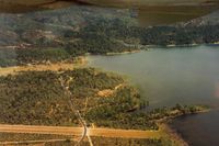  - This picture shows the road that crosses the south end of runway.While there are stop signs,vehicles do not always stop.Landing, a pilot should be prepared for this!!Seen more then one pilot startled when a car appeared when landing. - by S B J