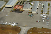  - Miami Executive airport.
Note the B-17 Aluminum Overcast parked by Landmark Aviation (orange building) - by Alex Feldstein