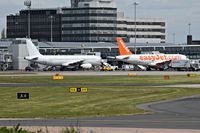  - on the left is LY-VEN A320 parked on its stand/gate and on the right is G-EZIL A319 EZY parked on its stand/gate - by andy-man-egcc