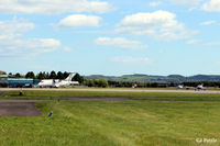  - A quiet regional airport, Dundee Riverside EGPN. An unmarked  Dornier 328 G-BZOG of Flybe/Loganair on the ramp ready for its return flight to London Stansted EGSS. A couple of Tayside Aviation trainers carry out pre-flight engine checks. - by Clive Pattle