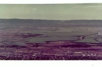  - Fremont airport is at the bottom of picture and Moffett Federal airport (NUQ) is above it seen in the distance. View is to the west.Picture is from 1986 soon after closure.Years of following the levees(at safe alt) sure helped flying coordination. - by S B J