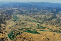  - Large cattle ranch strip near Patterson,Ca.till it was sold for development of high end homes.The paved runway is seen on the left where the road turns right.Flew over it many times but never landed. View is to the west. - by S B J