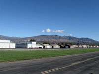  - Newer and older hangars. Santa Paula Peak at 4,957' in center right background. Hines Peak at 6,704' of Topa Topa Mountains beyond saddle barely shows near left side. - by Doug Robertson