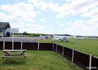  - Looking across the apron from the clubhouse of Sherburn Aero Club. The staff are very welcoming and the food is de-lish. If you ask nicely and have a Hi-Vis jacket you may get airside and hangar access. - by Clive Pattle