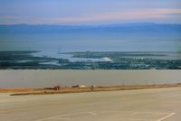  - Top picture is view to the east and the main reporting point when flying in from that direction, which is the cement plant . I reported over it many times.This pic also shows the amazing Howard Hughes Mining Barge I which was there in the mid 80s. - by S B J