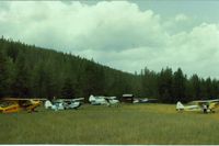  - Spotted Bear with view to the NW. This is the main camping and tiedown area.The truck seen behind my Piper Colt, was for transportation to the near by lodge.Yes indeed, it was nice for these taildragger pilots to let me fly along. - by S B J