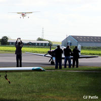 - Spotters doing what they do best at Breighton EGBR during the 'Radial Fly-in' - I don't know what difference holding your camera up in the air above your head makes ! - by Clive Pattle