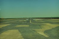  - View down runway 12.At one point the FAA said the threshold was to near an existing irrigation ditch, so airport was closed.Somebody came up with the idea of moving threshold  down 300 feet as seen. FAA happy and airport reopened. - by S B J
