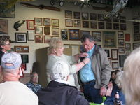  - Pat Quinn's Museum hangar on the occasion of his receiving the FAA Master Pilot Award for 50 years accident free-no violations flying. Arlys pinning her proud, well-deserved husband. - by Doug Robertson