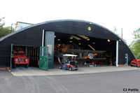  - A view of one of the many hangars at The Shuttleworth Trust, Old Warden Airfield, offering a tantalising glimpse of some of the aviation occupants inside. - by Clive Pattle