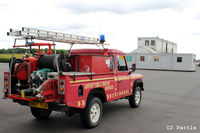  - The Fire Rescue Landrover at Turweston airfield with the temporary 'portacabin' ATC and Cafe accommodation in the background. - by Clive Pattle