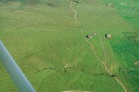  - Orvis ranch in central calif which was active in the 50s & 6os. The left hangar housed a Twin Bonanza C50 with a Cub in the far hangar. In the early 70s I flew over the C50 a mile east. It was only the fuselage.Never found out the story behind it.  - by S B J