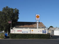  - Santa Paula Airport Self-Serve SHELL 100LL fuel dock. Location: Mid-Field North, fuel price unchanged, still lowest in Ventura County? Note flag showing east wind, wind tee and both windsocks confirmatory, yet were 5 downwind landings early on. - by Doug Robertson