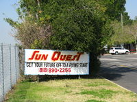  - Sun Quest Flight School sign at airport entrance - by Steve Nation