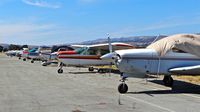  - Long line of locally-based single engine pistons at South County Airport, San Martin, CA. Most of these aircraft are non airworthiness. - by Chris Leipelt