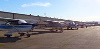  - This is the busiest you'll ever see this row of tie downs at Reid Hillview Airport. A lot of the aircraft seen here are in a temporary tie down to make room for all the transient Super Bowl 50 aircraft, however some normally park on this row. - by Chris Leipelt