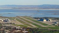  - Flying over Moffett Federal Airfield, Mountain View, CA with the Blue Angels parked on the left side of the image. - by Chris Leipelt