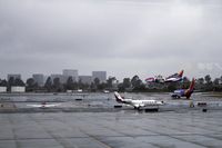  - Four a/c waiting to take off and a Southwest flight landing. - by Eric Olsen