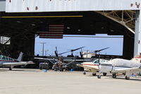  - Camarillo Aircraft hangar, both ends open. Ventura County Sheriff's Helicopter unit is in western half, some helicopters shown. Usual takeoffs/landings from adjacent ramp. Now in 2019 Sheriff/Ventura County Fire  has total hangar. - by Doug Robertson